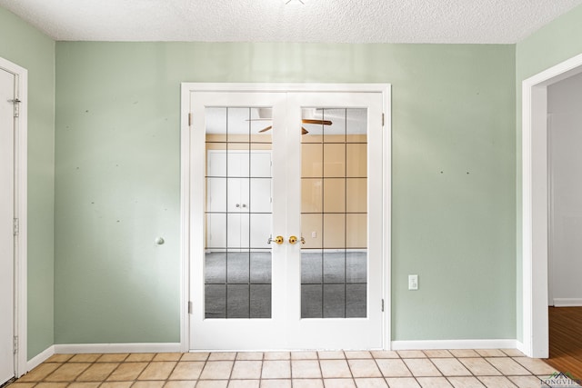 1208 Marigold Ln, Longview, TX 75604 - doorway featuring french doors, baseboards, ceiling fan, and a textured ceiling