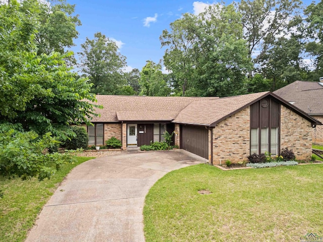 1208 Marigold Ln, Longview, TX 75604 - mid-century home with brick siding, concrete driveway, a front yard, roof with shingles, and a garage