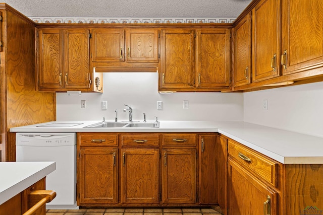 1208 Marigold Ln, Longview, TX 75604 - kitchen featuring a sink, white dishwasher, light countertops, and brown cabinetry