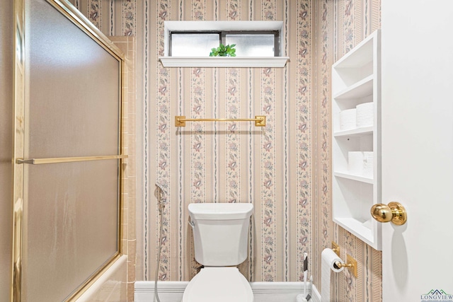 1208 Marigold Ln, Longview, TX 75604 - bathroom with wallpapered walls, toilet, and shower / bath combination with glass door