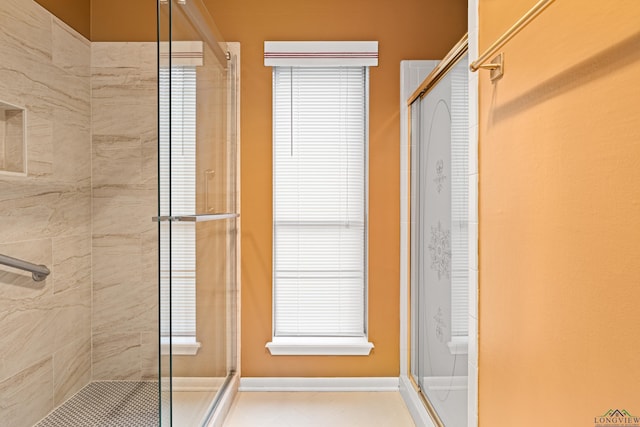 1208 Marigold Ln, Longview, TX 75604 - bathroom with a stall shower and baseboards