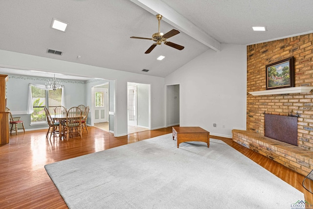 1208 Marigold Ln, Longview, TX 75604 - living room featuring wood finished floors, a brick fireplace, ceiling fan, baseboards, and a textured ceiling