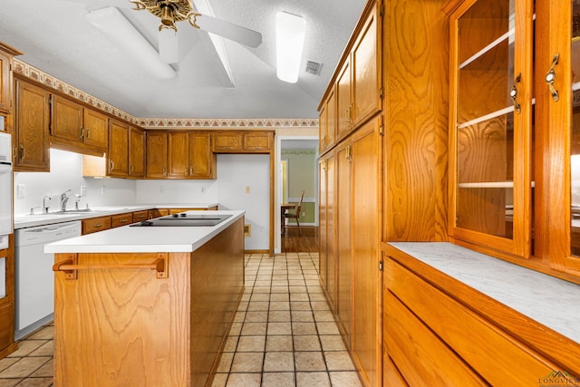 1208 Marigold Ln, Longview, TX 75604 - kitchen featuring dishwasher, black electric cooktop, a ceiling fan, a sink, and brown cabinets