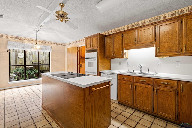 1208 Marigold Ln, Longview, TX 75604 - kitchen featuring a sink, white appliances, a textured ceiling, a ceiling fan, and a center island