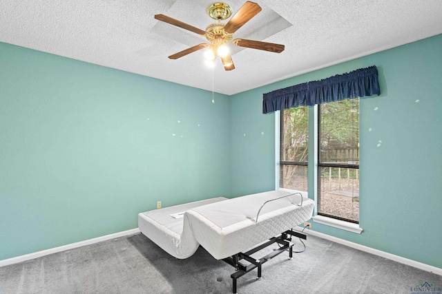 1208 Marigold Ln, Longview, TX 75604 - bedroom featuring baseboards, a textured ceiling, carpet flooring, and a ceiling fan