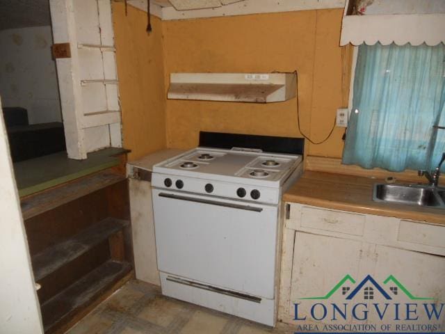 kitchen featuring white stove and sink