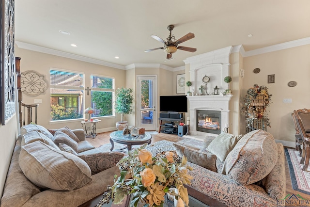 living room with crown molding, ceiling fan, a fireplace, and hardwood / wood-style floors