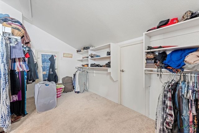 spacious closet with carpet flooring and vaulted ceiling