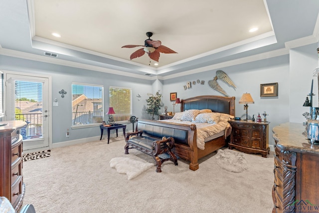 bedroom featuring access to exterior, light carpet, a raised ceiling, and ceiling fan