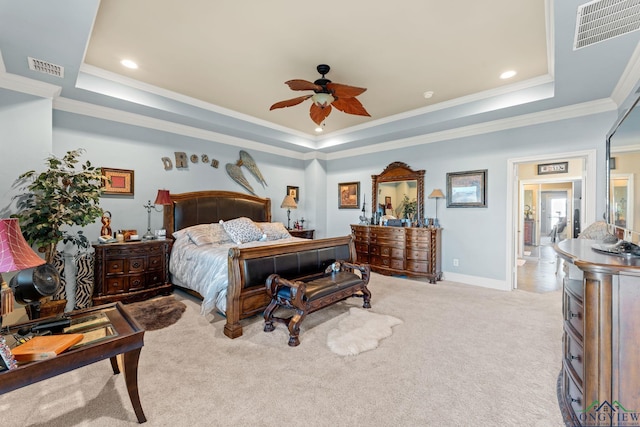 carpeted bedroom featuring ceiling fan, ornamental molding, and a tray ceiling