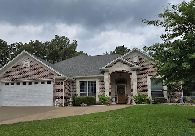 3720 Bill Owens Pkwy, Longview, TX 75605 - view of front facade featuring brick siding, a front lawn, roof with shingles, an attached garage, and driveway