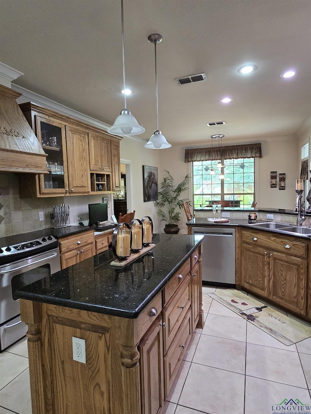 3720 Bill Owens Pkwy, Longview, TX 75605 - kitchen featuring appliances with stainless steel finishes, premium range hood, brown cabinets, glass insert cabinets, and light tile patterned floors