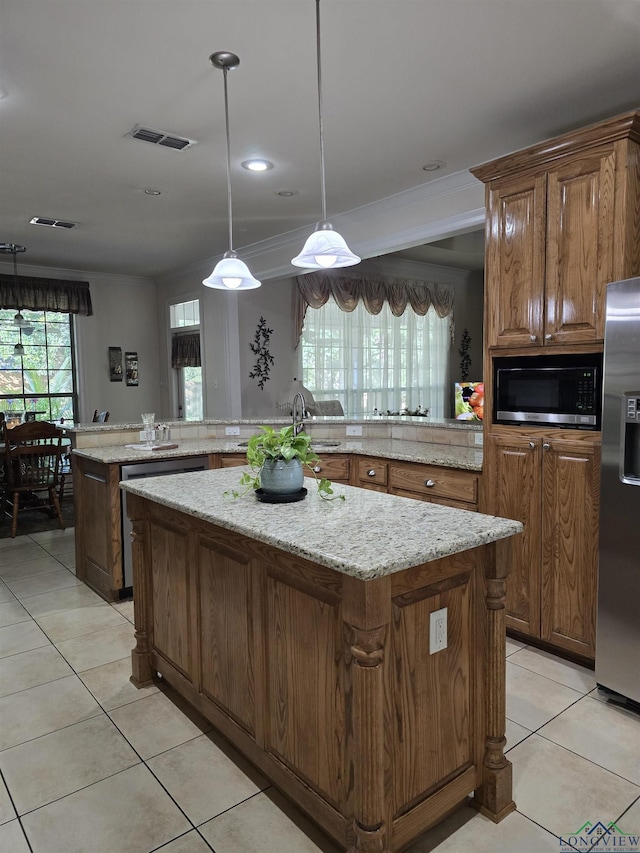 3720 Bill Owens Pkwy, Longview, TX 75605 - kitchen with stainless steel refrigerator with ice dispenser, a center island, light tile patterned floors, light stone countertops, and pendant lighting