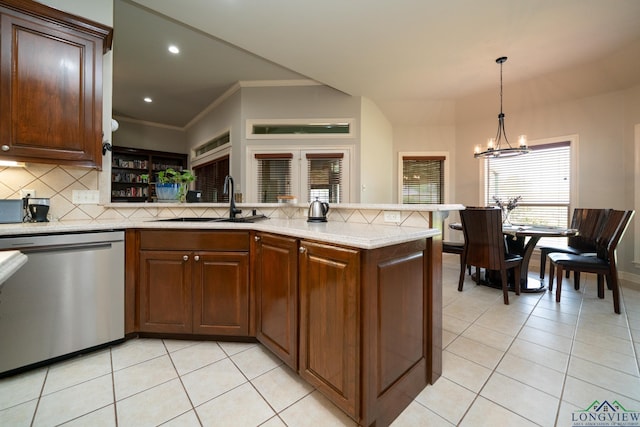 kitchen featuring light tile patterned flooring, sink, hanging light fixtures, stainless steel dishwasher, and kitchen peninsula