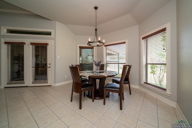 dining space with lofted ceiling, a notable chandelier, and light tile patterned flooring