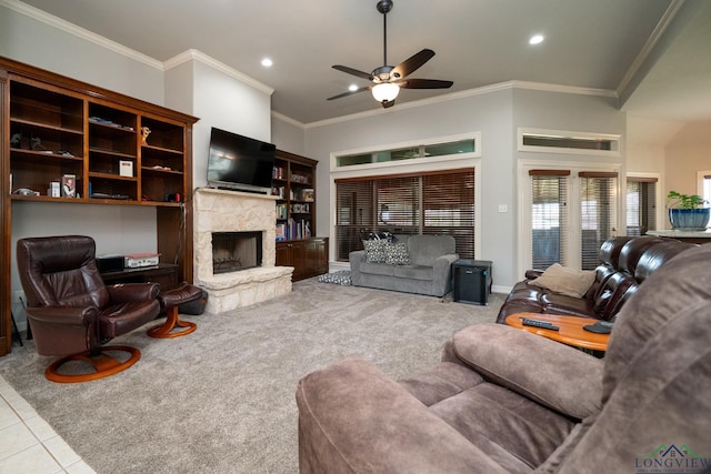 living room featuring ceiling fan, light colored carpet, ornamental molding, and a stone fireplace