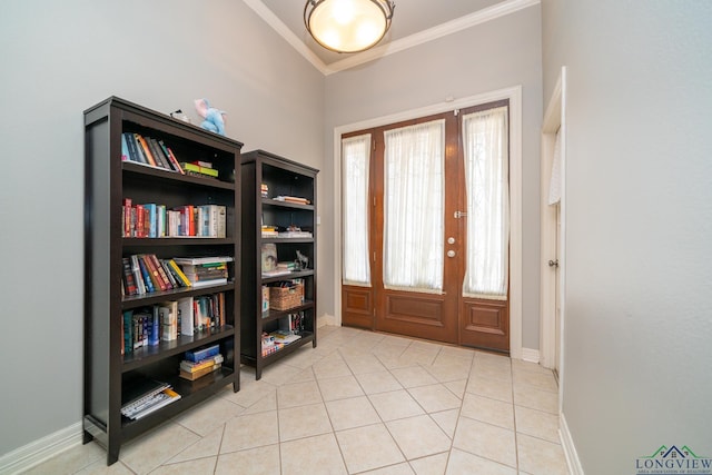 tiled entrance foyer featuring crown molding and plenty of natural light