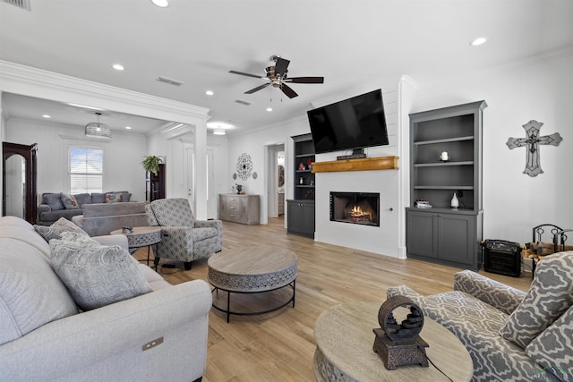 113 Saddle Brook Cir, Hallsville, TX 75650 - living area featuring a ceiling fan, recessed lighting, crown molding, a fireplace, and light wood-type flooring