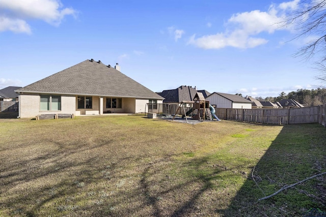 113 Saddle Brook Cir, Hallsville, TX 75650 - back of property featuring a playground, a fenced backyard, and a shingled roof