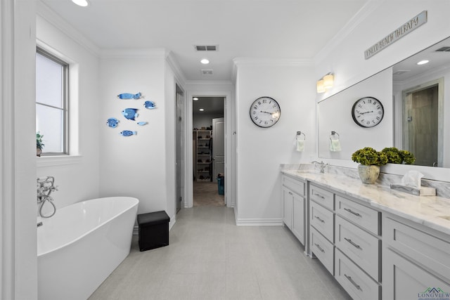 113 Saddle Brook Cir, Hallsville, TX 75650 - full bath featuring double vanity, a freestanding bath, a walk in closet, recessed lighting, and crown molding