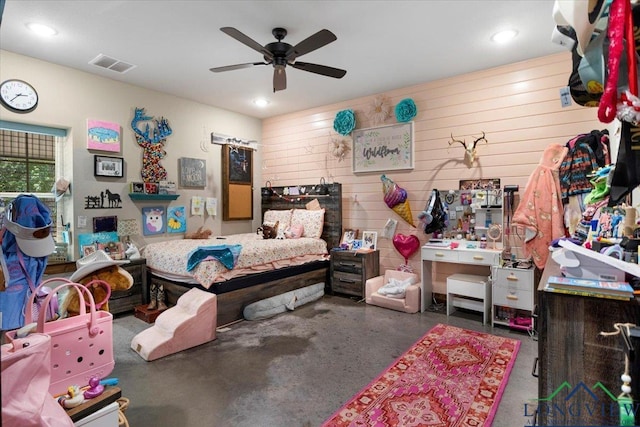 15136 Fm 852, Gilmer, TX 75644 - bedroom featuring concrete floors, wooden walls, recessed lighting, and a ceiling fan