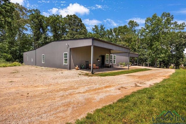 15136 Fm 852, Gilmer, TX 75644 - view of property exterior with driveway, a patio area, and a carport