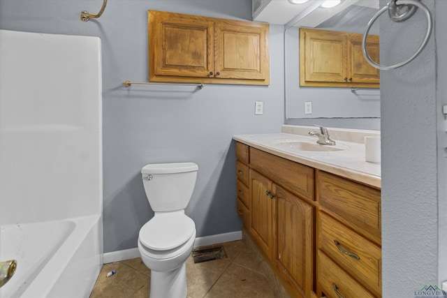 bathroom with toilet, vanity, and tile patterned floors