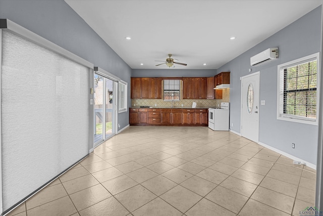 kitchen featuring white range with electric stovetop, ceiling fan, tasteful backsplash, and plenty of natural light