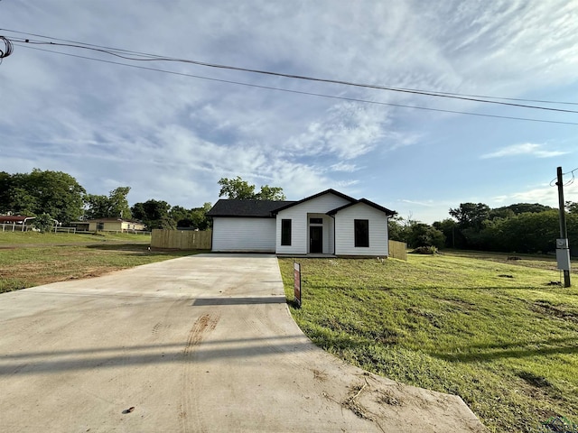 208 W Houston St, Daingerfield, TX 75638 - view of front facade featuring concrete driveway and a front yard