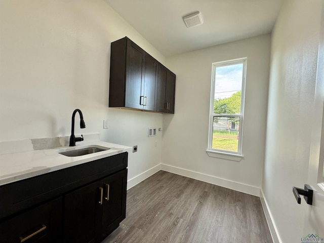 208 W Houston St, Daingerfield, TX 75638 - laundry area with washer hookup, hookup for an electric dryer, cabinet space, dark wood-style floors, and baseboards