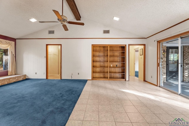 unfurnished living room featuring a wealth of natural light, lofted ceiling with beams, and a textured ceiling