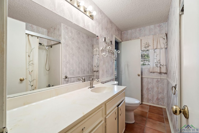 bathroom with vanity, a textured ceiling, tile patterned flooring, toilet, and curtained shower