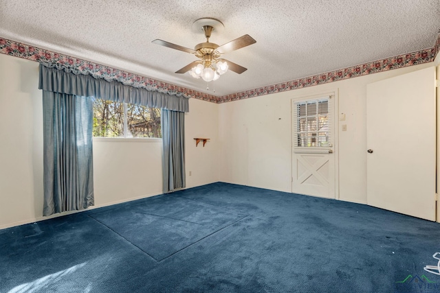 carpeted spare room featuring ceiling fan and a textured ceiling