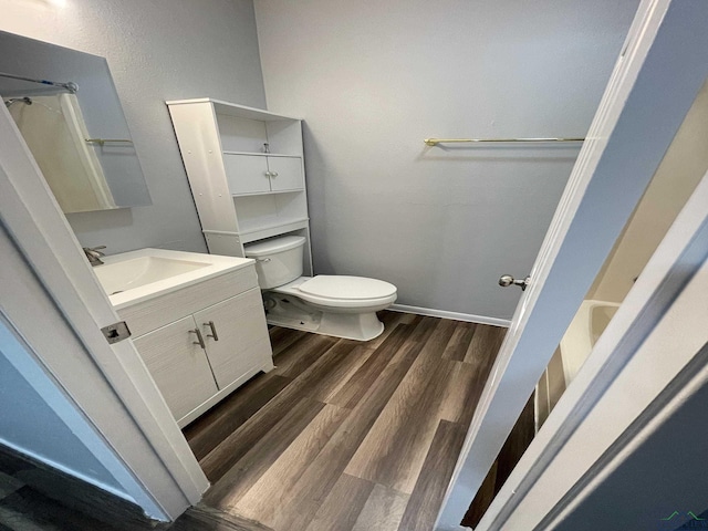 bathroom with vanity, wood-type flooring, and toilet