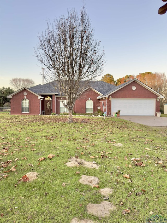 ranch-style house with a front yard and a garage