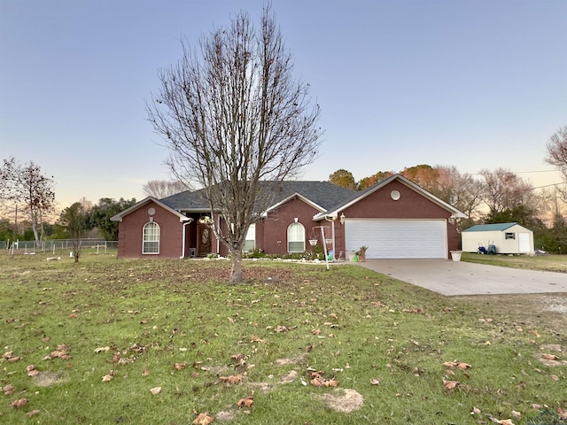 single story home with a lawn and a garage