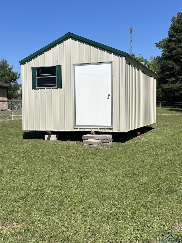 view of outbuilding with a yard