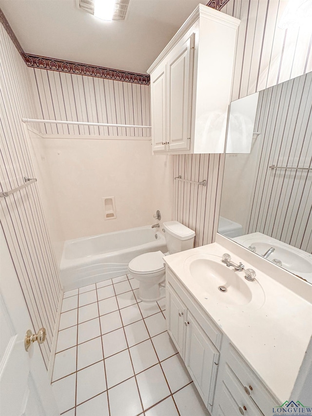 bathroom featuring toilet, tile patterned flooring, vanity, and  shower combination