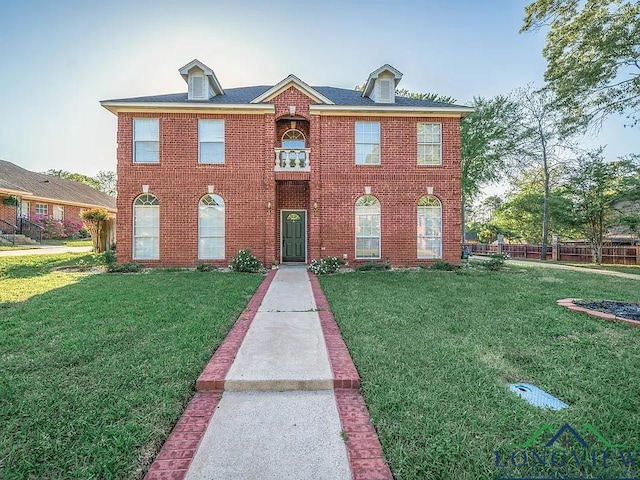 view of front of home featuring a front lawn and brick siding