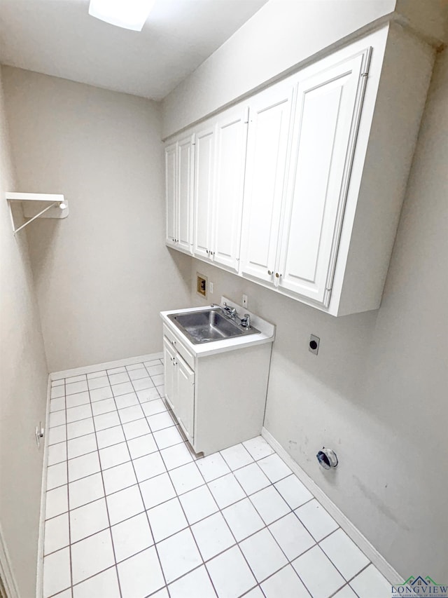 laundry area featuring hookup for an electric dryer, a sink, cabinet space, hookup for a washing machine, and baseboards