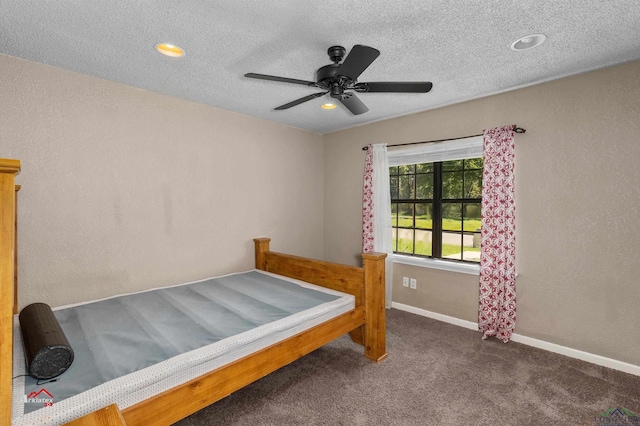 bedroom featuring dark colored carpet and ceiling fan