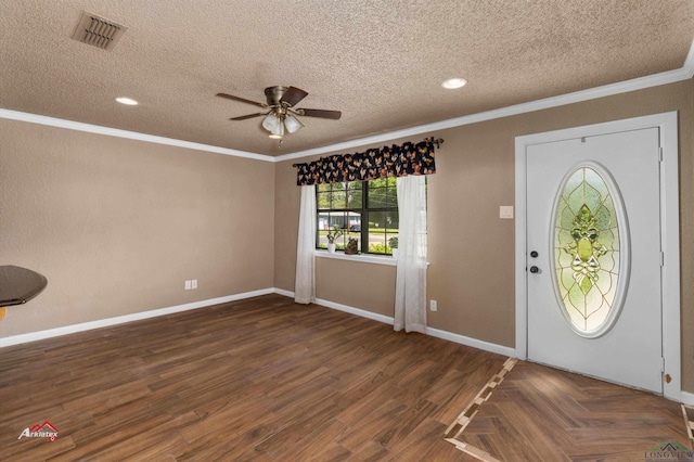 entrance foyer with ceiling fan, a textured ceiling, and ornamental molding