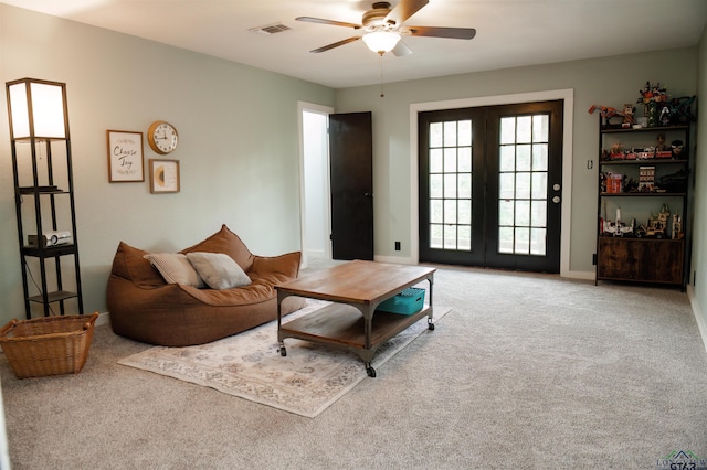 living room with ceiling fan, carpet floors, and french doors