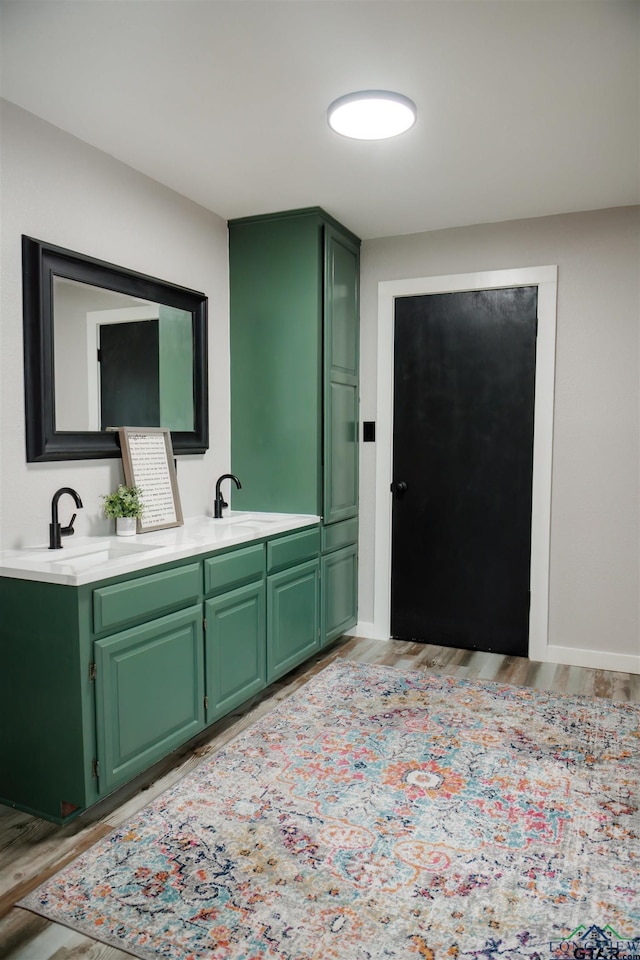 bathroom with vanity and hardwood / wood-style flooring