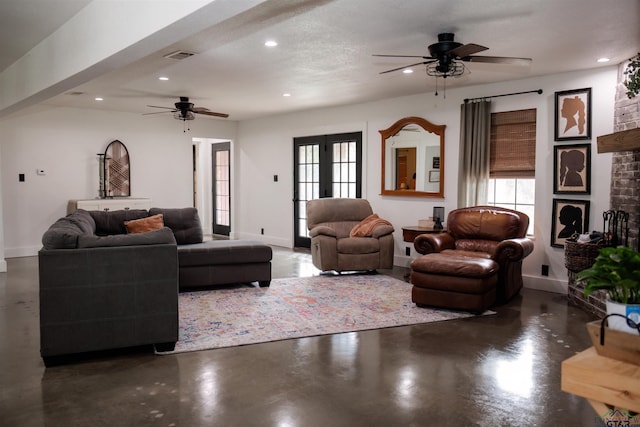 living room with ceiling fan, french doors, and a textured ceiling