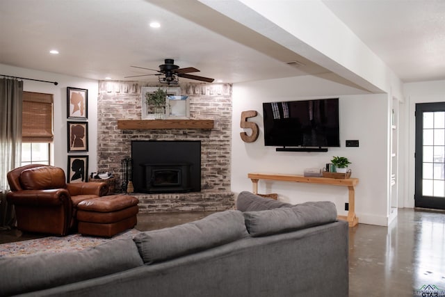 living room with ceiling fan and concrete floors