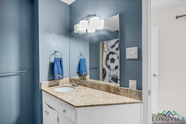 918 S Evenside St, Henderson, TX 75654 - bathroom featuring vanity and a textured wall