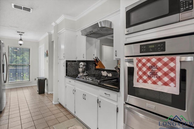 918 S Evenside St, Henderson, TX 75654 - kitchen featuring stainless steel appliances, ornamental molding, exhaust hood, dark countertops, and white cabinets
