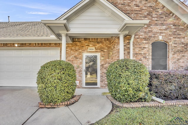 view of exterior entry featuring a garage