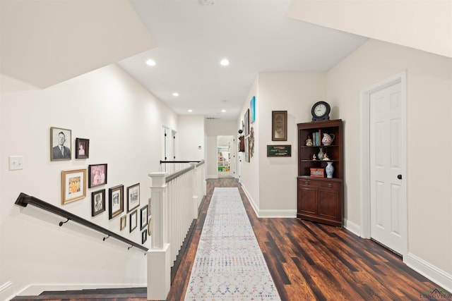 1307 Yates Dr, Longview, TX 75601 - hall with an upstairs landing, dark wood-style flooring, baseboards, and recessed lighting